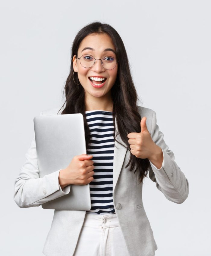 Business, finance and employment, female successful entrepreneurs concept. Young confident businesswoman in glasses, showing thumbs-up gesture, hold laptop, guarantee best service quality.